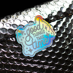 Good Things Take Time custom holographic sticker. White text reads. Good things take time. 