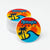 Stack of 'Atlantic Beach' circle stickers with a retro design featuring palm trees and waves on a white background.