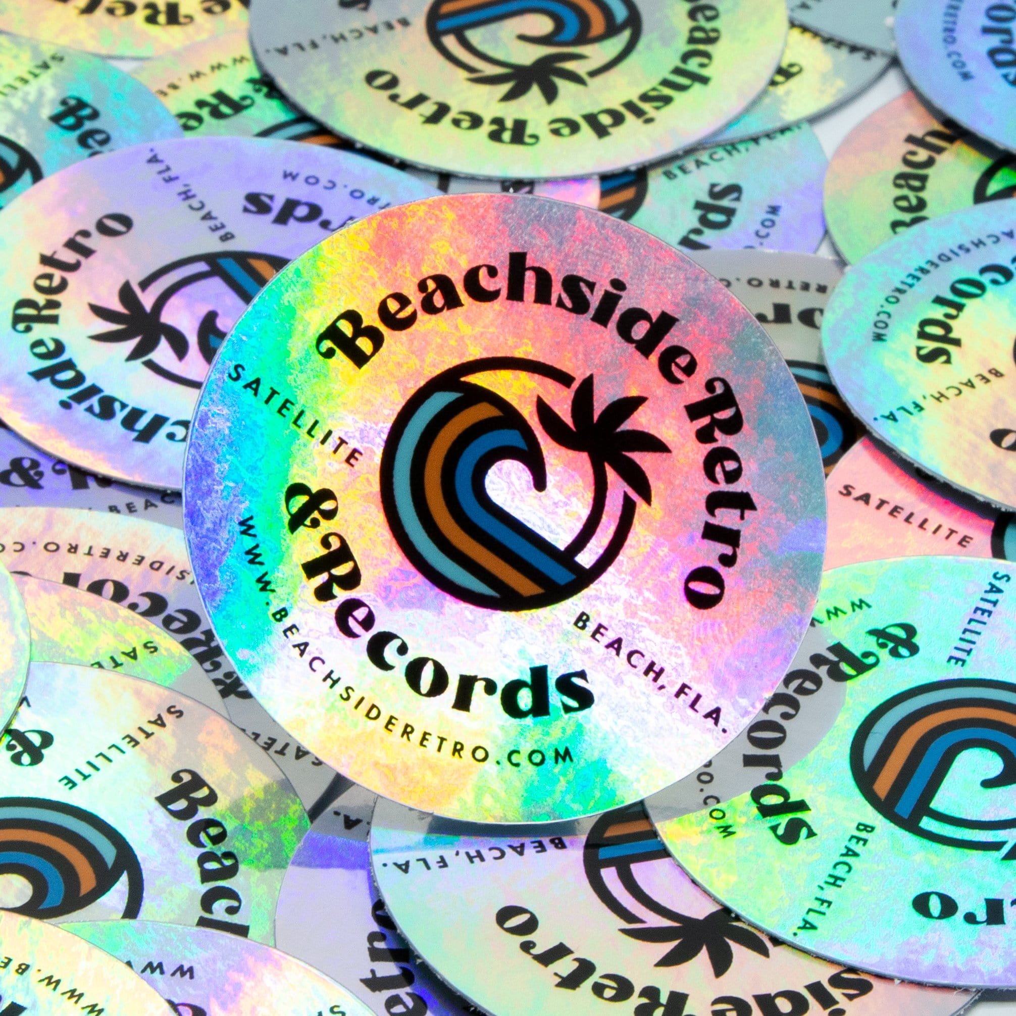 Beachside Retro Records holographic stickers for a vinyl record shop. Text reads. Beachside Rettro & Records. Satellite. Beach, FLA. www.beachsideretro.com