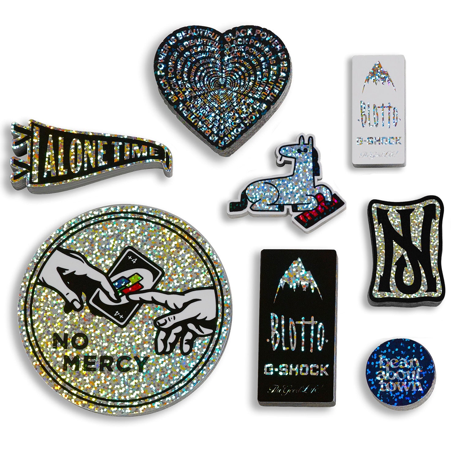 Various glitter holographic stickers of horse plays keyboard blotto gshock NJ Skateshop. UNO playing card. 'Alone time' pendant Text reads bean about town. no mercy. alone time. black power blotto. gshock. nj. 