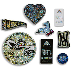 Various glitter holographic stickers of horse plays keyboard blotto gshock NJ Skateshop. UNO playing card. 'Alone time' pendant Text reads bean about town. no mercy. alone time. black power blotto. gshock. nj. 