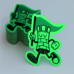 Stack of green superhero-themed Glow in the dark stickers black and green on gray low light background 