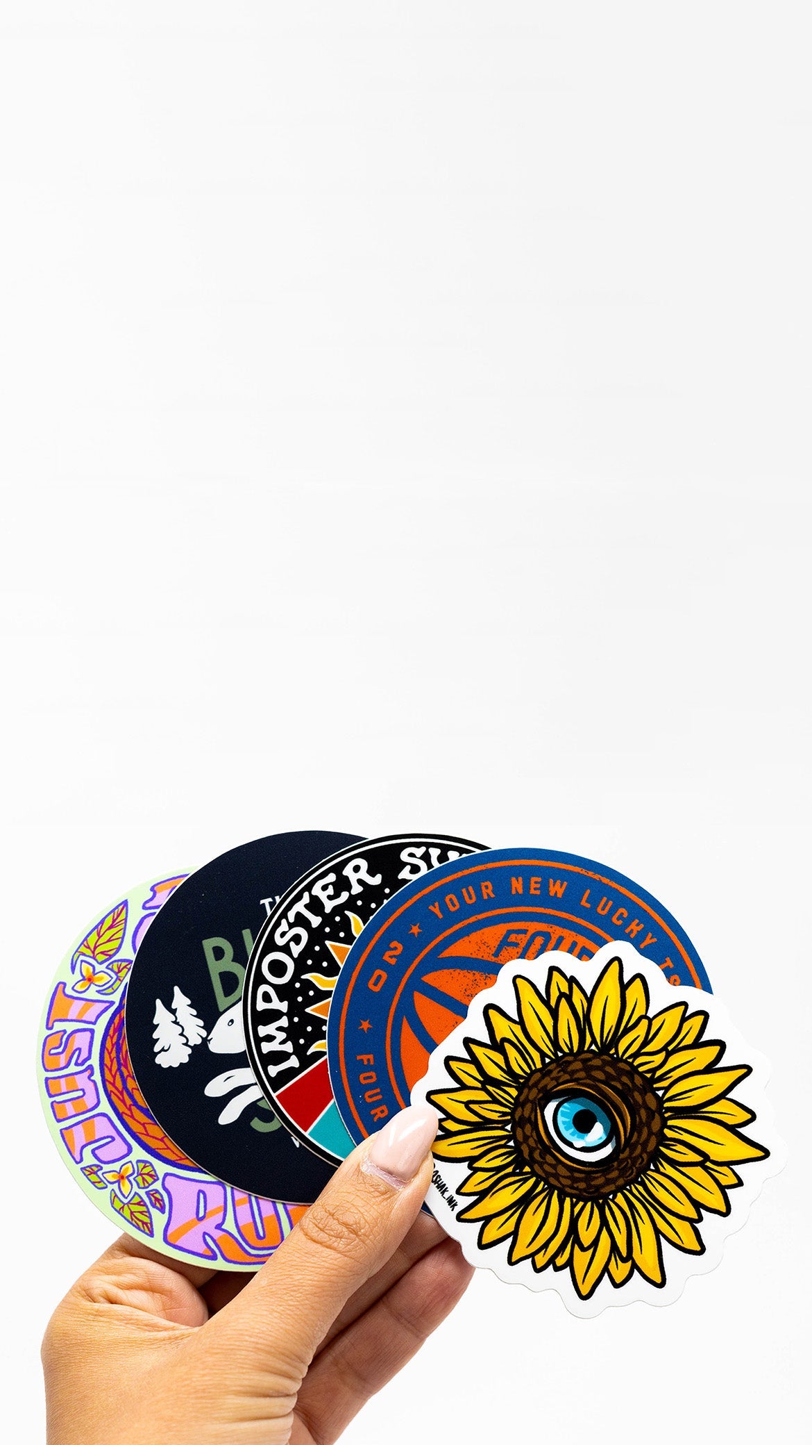 Hand holding custom vinyl die cut stickers with illustrations and graphic images of sunflower basketball brand logo and rabbit