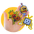 Graphic of hand holding colorful illustrated stickers of a cat playing guitar a party hamburger with sunglasses and a television robot on yellow background